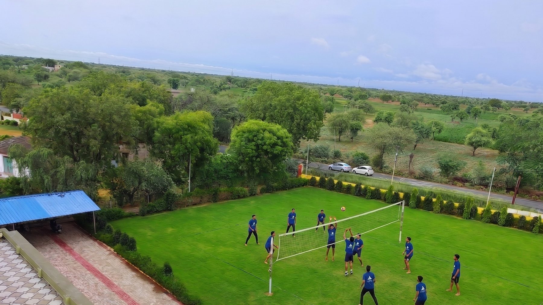Students playing volleyball on the academy grounds