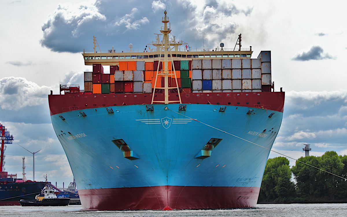 A laden container ship seen bow-on