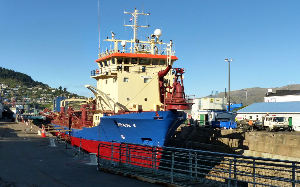 A trailing suction hopper dredger alongside