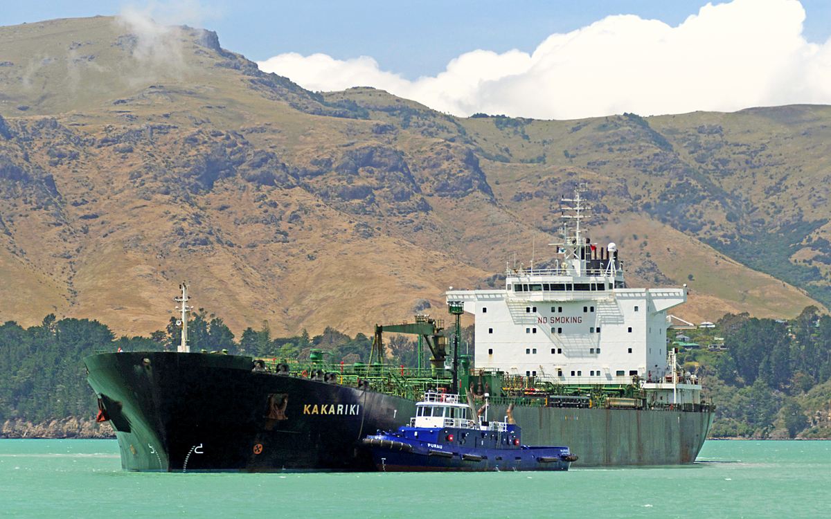 A crude oil tanker under tug escort